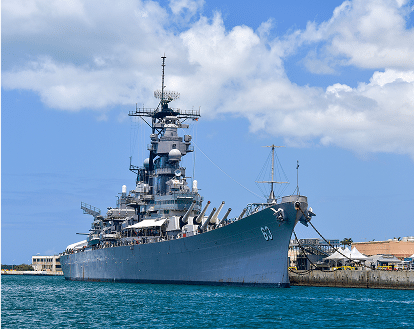 A navy ship at a harbour