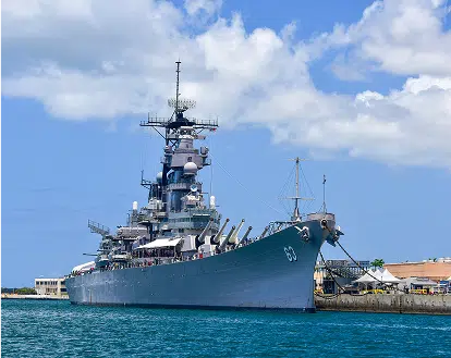 A navy ship at a harbour