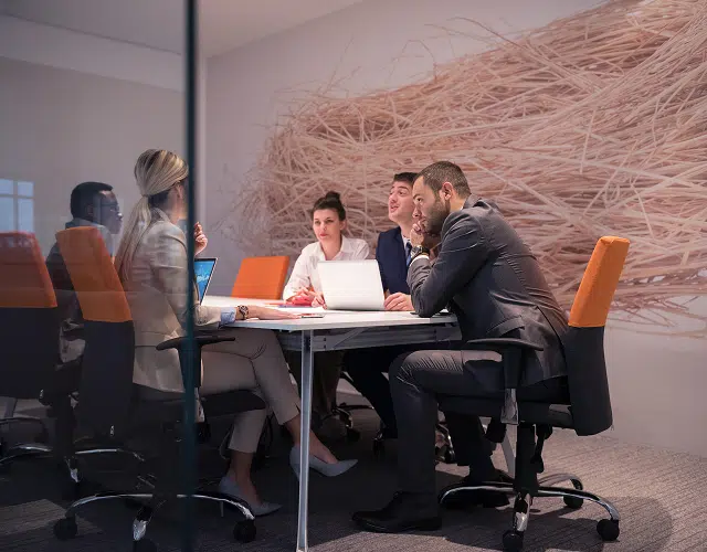 people talking around a boardroom table