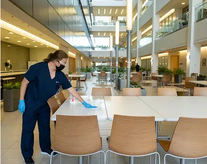 A woman cleaning tables