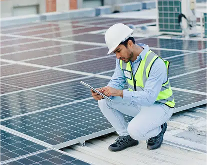 A worker reviewing solar panels