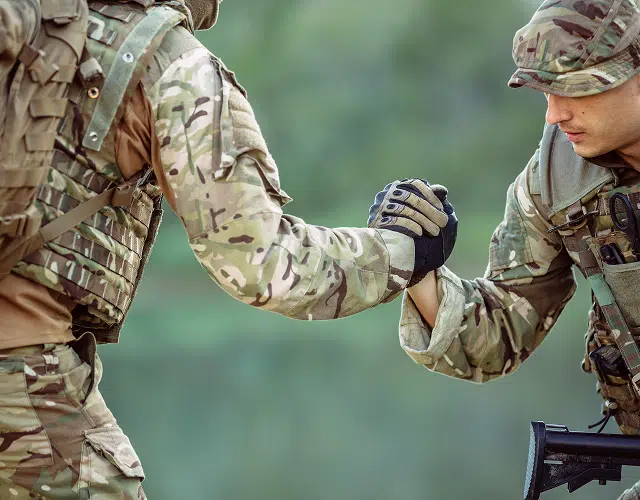 One solider helping another