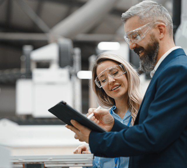 A man and woman looking at a clip board