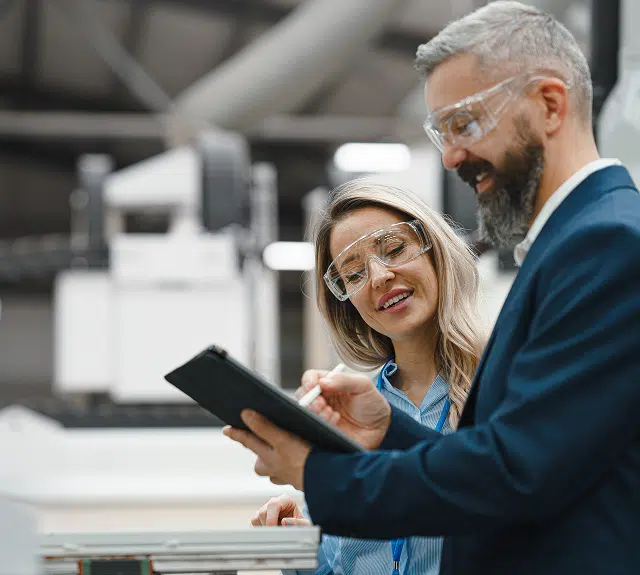 A man and woman looking at a clip board