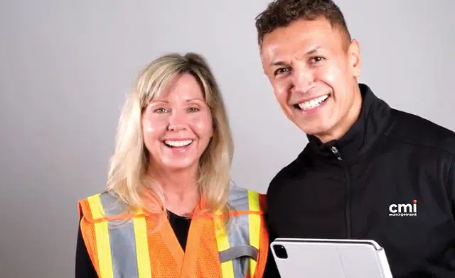Image of two workers smiling